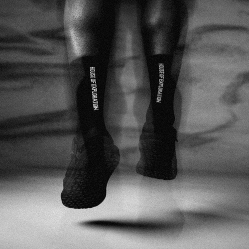 blurry-image-of-man-wearing-h-o-e-socks-and-jumping