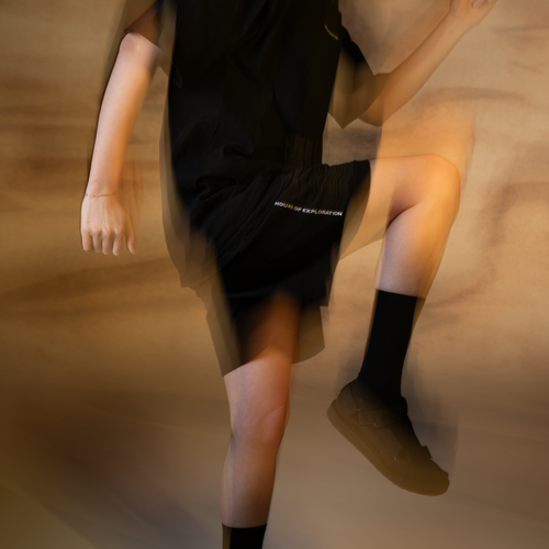 lifestyle-image-of-woman-wearing-the-h-o-e-limited-edition-jersey-shorts-image-blurred