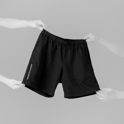 hands-holding-house-of-exploration-jersey-shorts-front