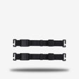 Two black adjustable webbing straps with quick-release plastic buckles, shown horizontally on a light gray background with a soft drop shadow.